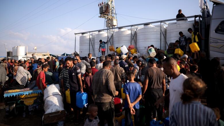 People gather in front of an aid truck.