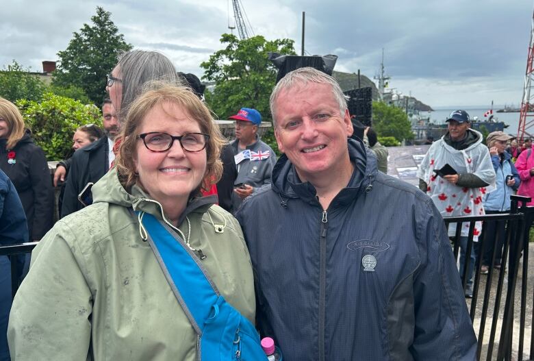 Woman with green coat and man in navy jacket. 