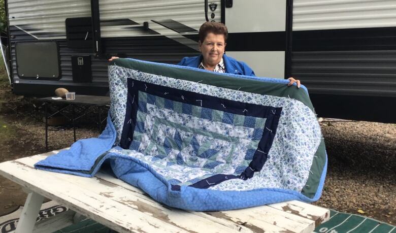 Nancy Cohen with a quilt she bought at an antique store in Indian Head.