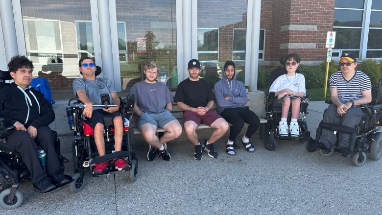 Some members of the Calgary Selects electric wheelchair hockey team at London, Ont.'s Fanshawe College on Tuesday, July 2. The 20-member team have been stranded in the city after their flights back to Calgary were cancelled. 