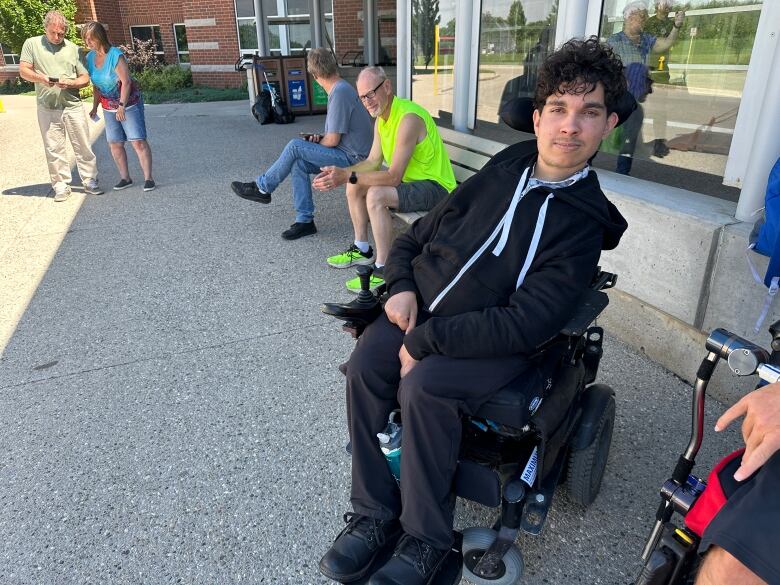 Calgary Selects' goaltender Ishan Manerikar, 23, says he's running low on important medication and missing doses can result in serious muscular issues, he said. Behind him on the far left are Tracy Petruska and her husband scrambling to rebook their flights. 