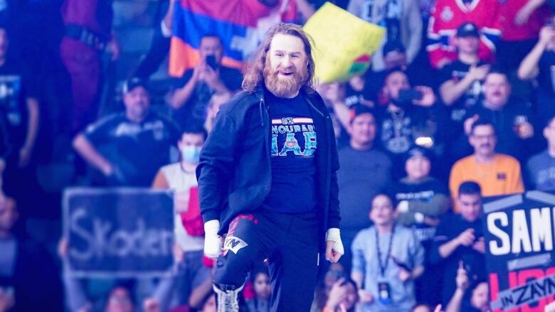 Canadian WWE Superstar Sami Zayn stands on top of the wrestling ring ropes at a Smack Down show in Montreal, Que. on Feb. 17, 2023. 