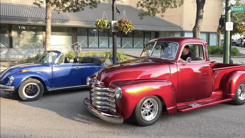 A car show on a downtown street.