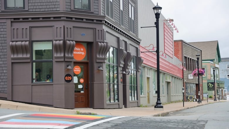 A grey-brown building on an empty street 