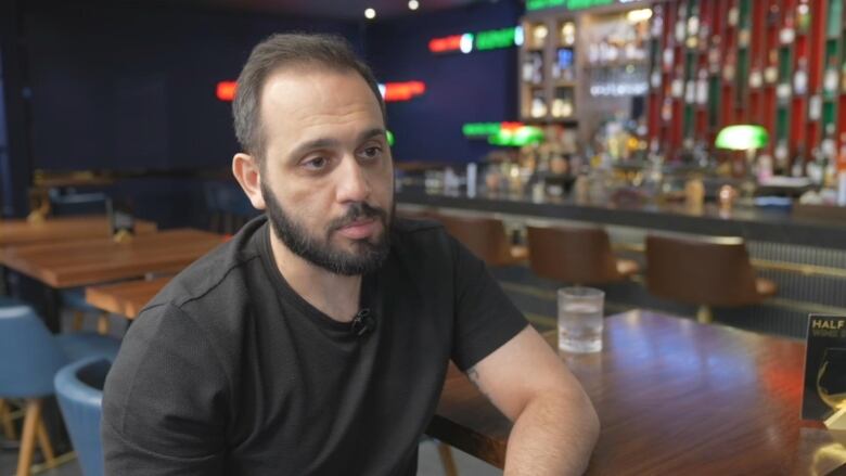 Man speaking at a bar