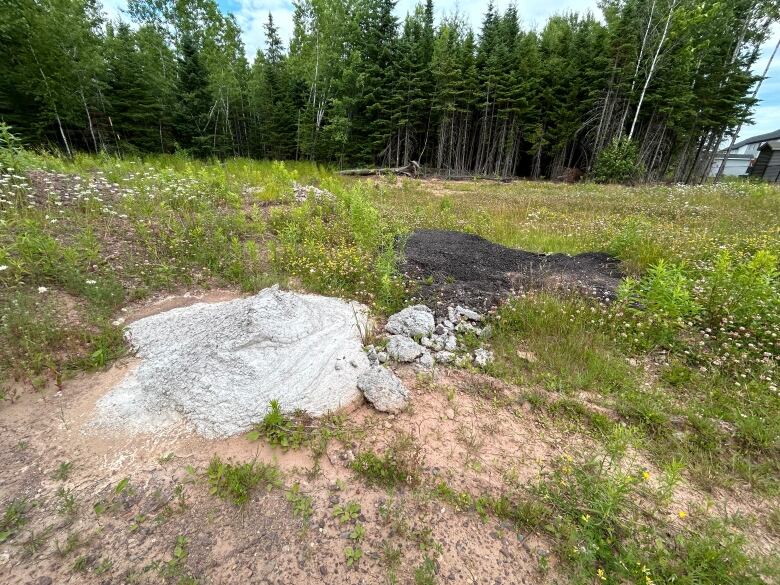 A pile of cement and asphalt dumped on public land.