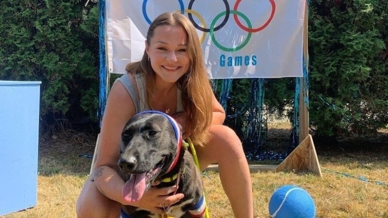 A woman holds a dog