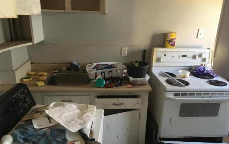 Interior, kitchen area, of dilapidated building.