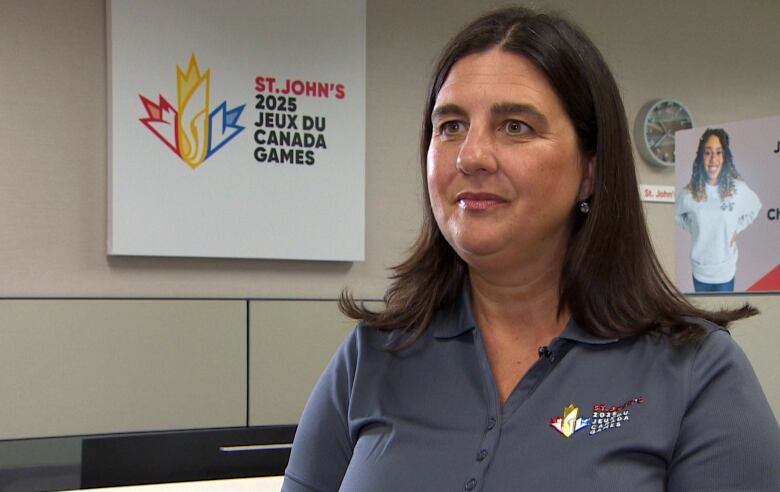 Woman with brown hair and grey shirt.