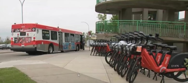 Red-ebikes in the foreground with a bus in the background