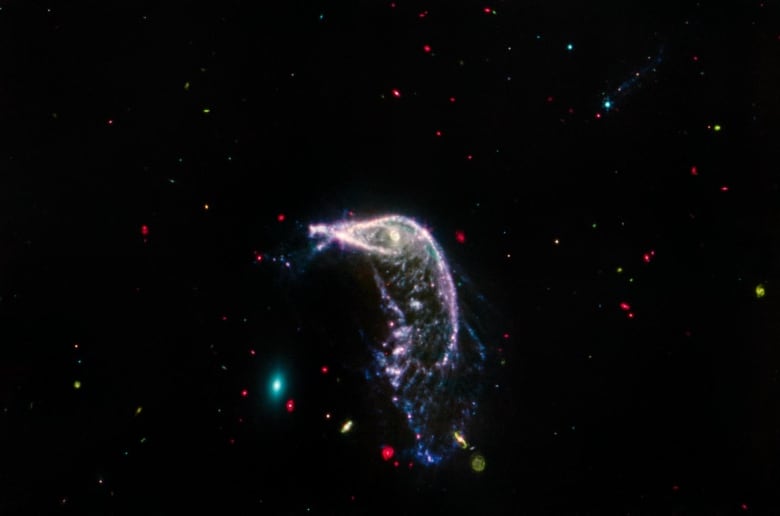 A penguin-looking galaxy sits in the blackness of space.