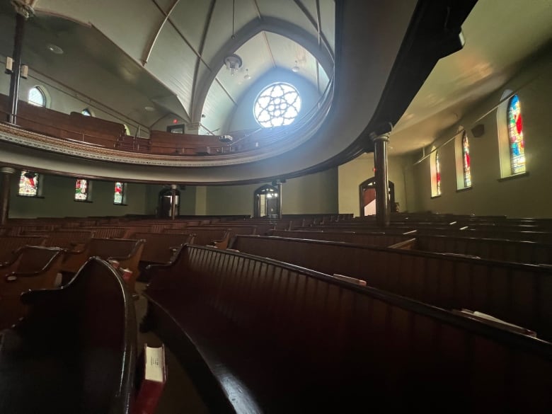 A church interior with a large glass window.