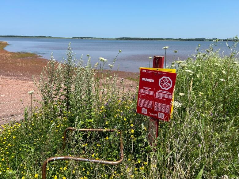 Red sign by the beach.