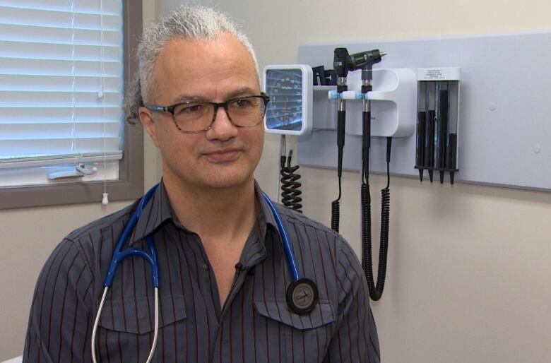 Man with grey hair and stethoscope around his neck. 