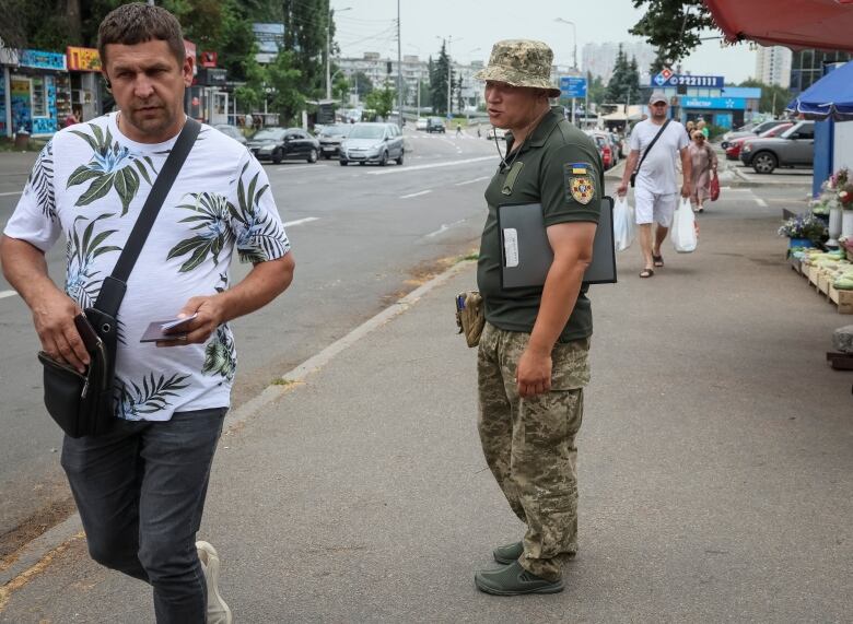 A Ukrainian military recruitment officer is seen in Kyiv earlier this month.