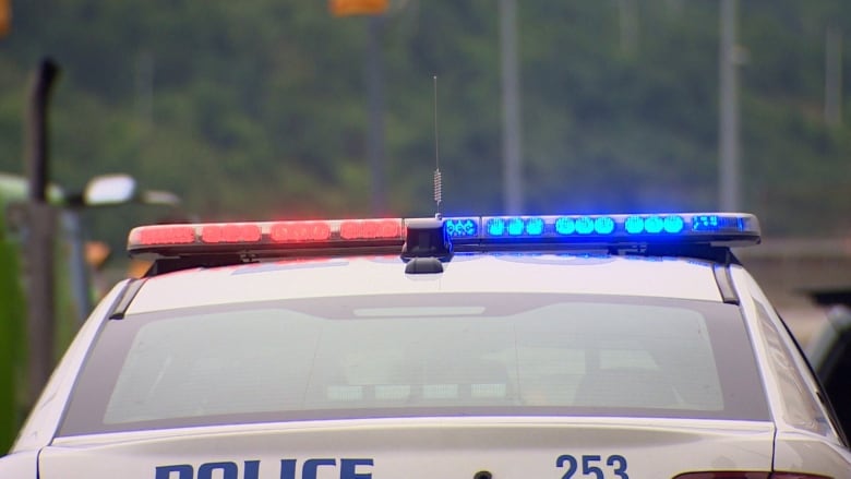 A police vehicle with red and blue lights flashing. 