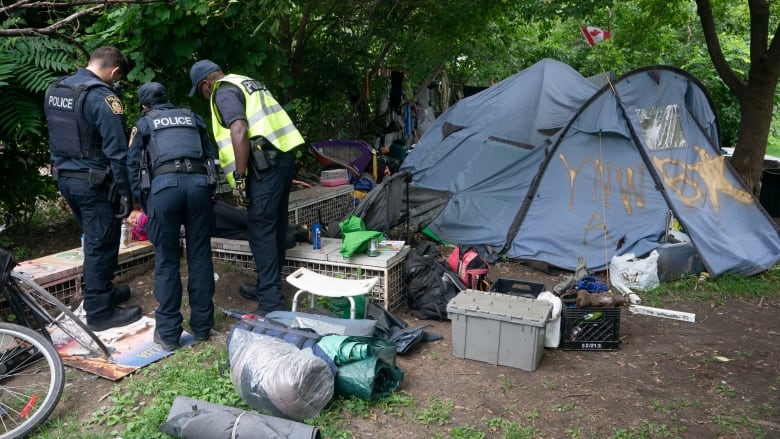 police dismantling a homeless encampment