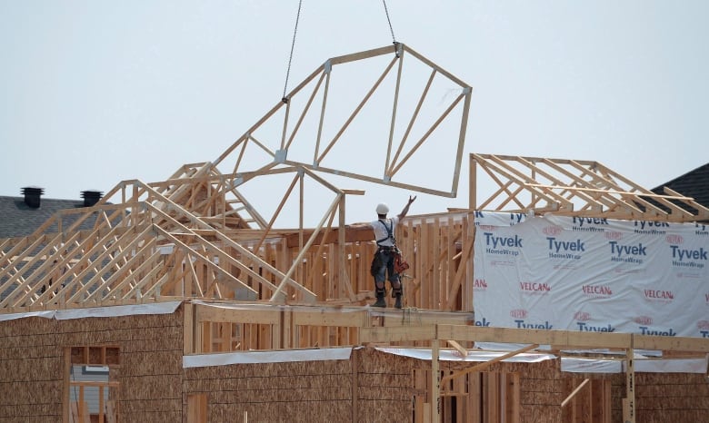 A man stands atop of a construction project.