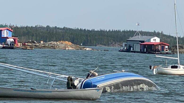 A tipped over sail boat.