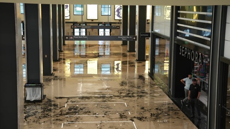 Photograph of wet muddled floor in Union Station after flooding. 