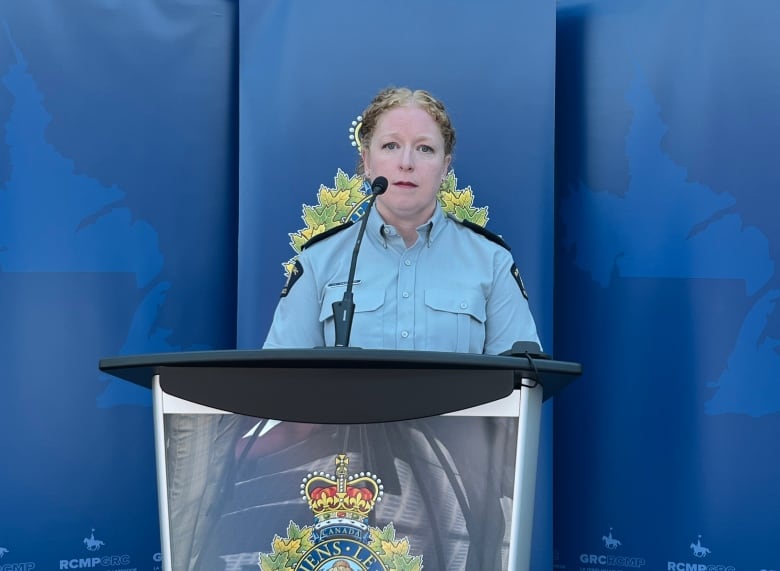 A woman stands behind a podium.