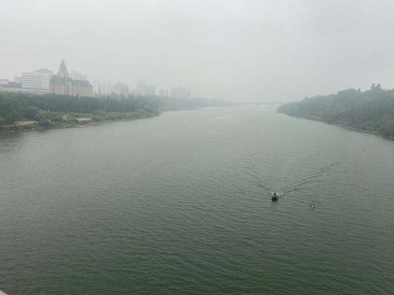 A couple of boaters endure the thick smoke which settled over the South Saskatchewan River Monday morning. 