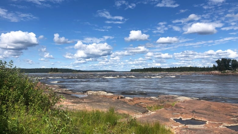 River with blue sky overhead.