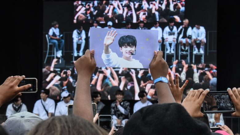 Stray Kids, a popular Korean band, answer questions on stage at a convention.