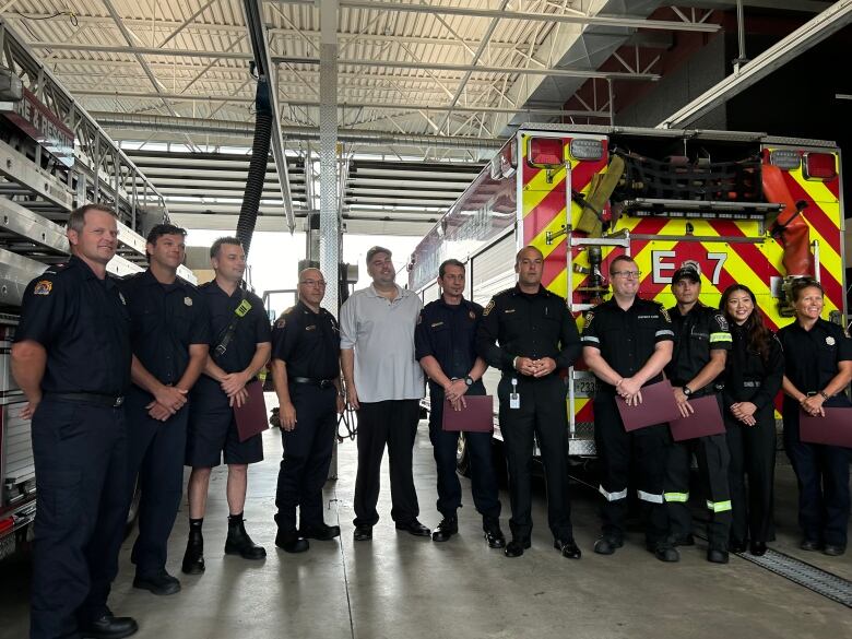 A man standing in a line with firefighters in uniform