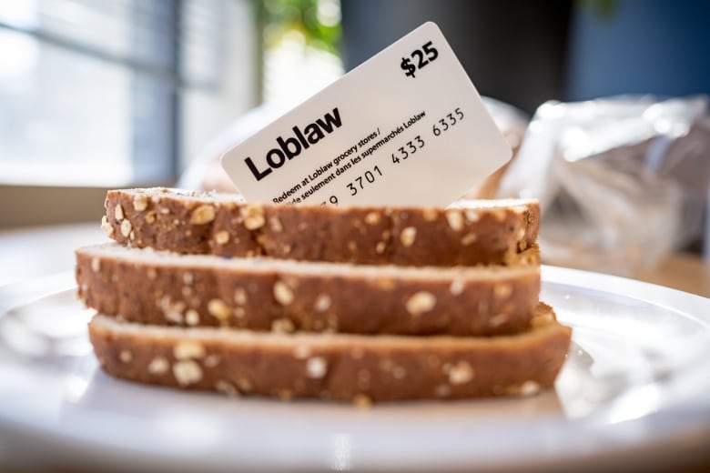 A sandwich and a gift card are shown in closeup.