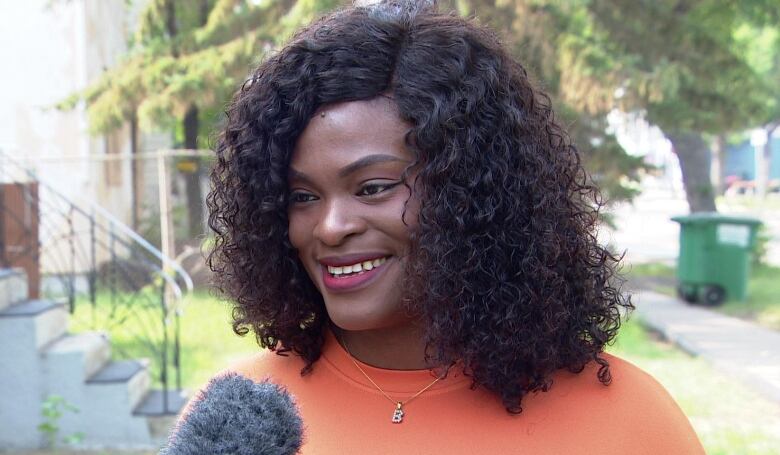 A woman in an orange t shirt 