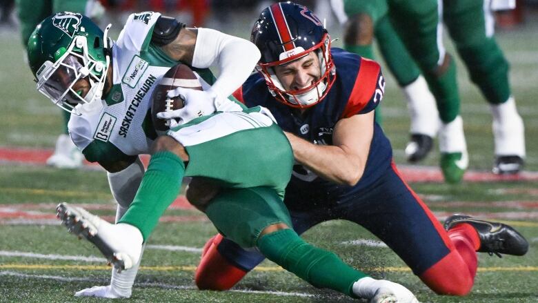 Montreal Alouettes' Joseph Zema, right, tackles Saskatchewan Roughriders' Marcus Sayles during first half CFL football action in Montreal, Thursday, July 25, 2024. 