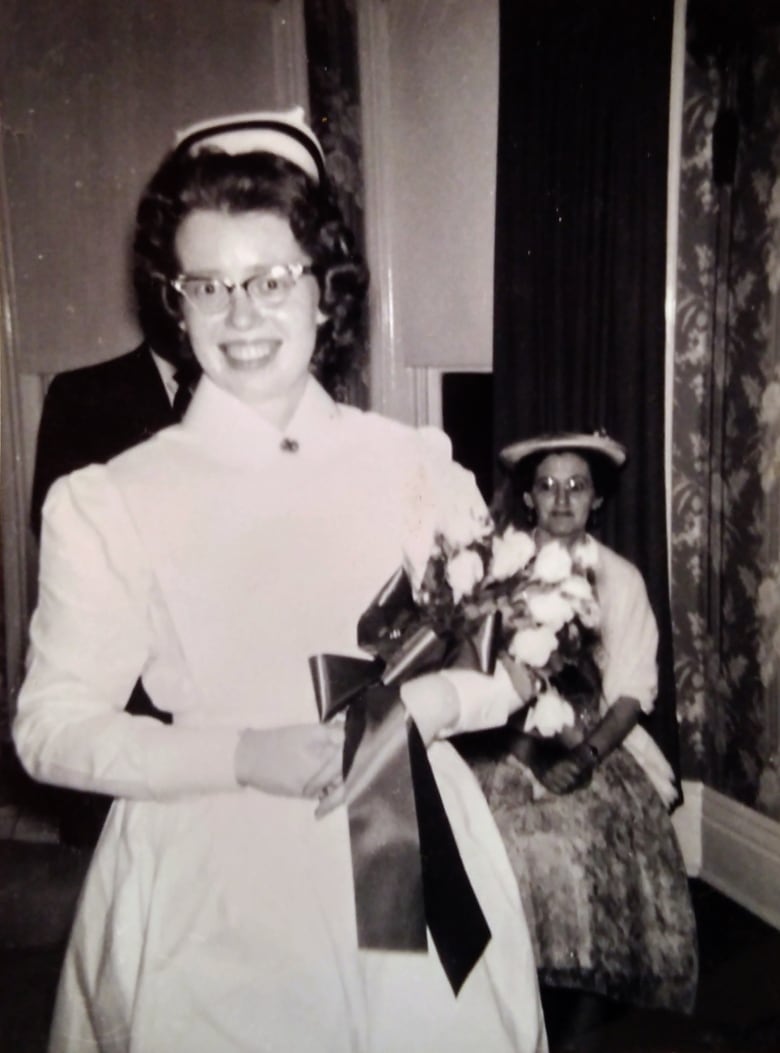 An old image of a woman during her graduation ceremony.