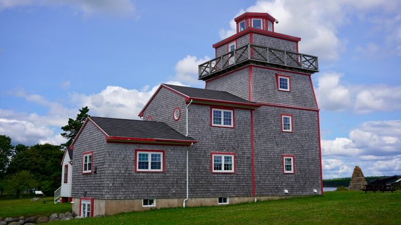 A grey building with red trim.