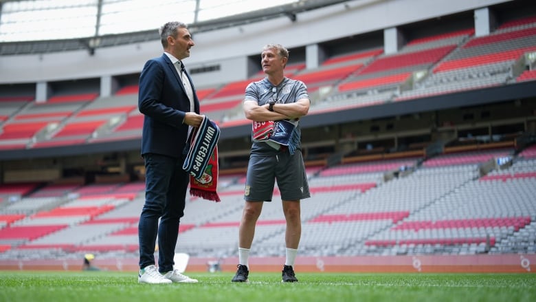 Two men on a soccer field.