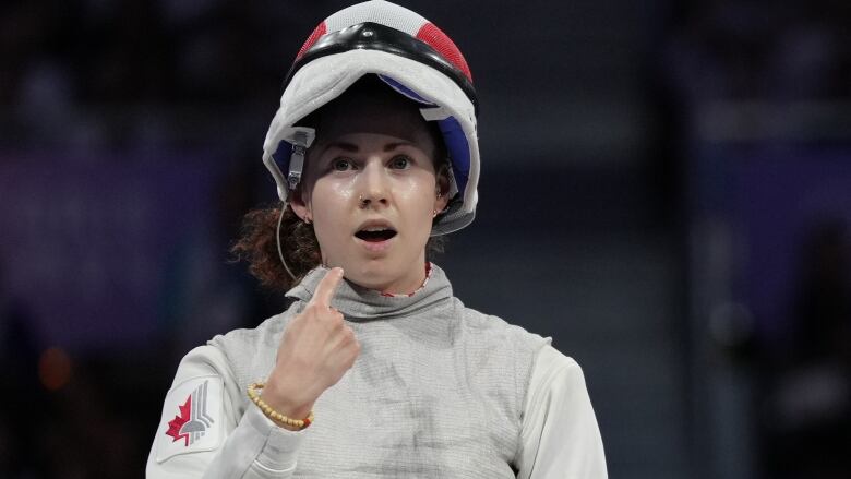 Canadian female fencer reacts after winning the bronze-medal match against an Italian female opponent n women's foil individual fencing in Paris, France on Sunday, July 28, 2024.