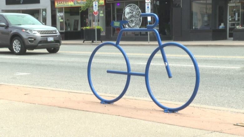 A bicycle-shaped bike rack.