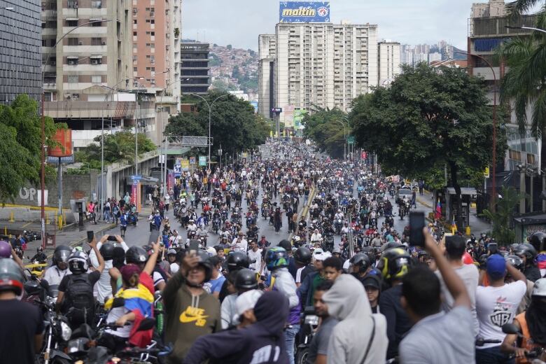 Protesters march and ride motorcycles in Caracas as they demonstrate against the official election results declaring President Nicolas Maduro the winner, the day after the presidential election in Venezuela, on Monday, July 29, 2024.