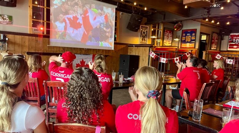 People watch sports in a bar.