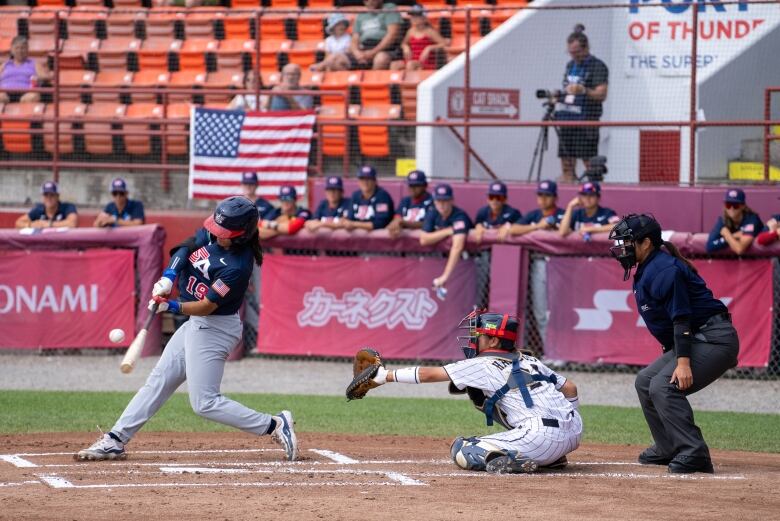 A batter swings at a ball during a baseball game.