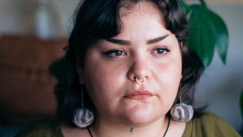 The book's author, a woman with shoulder-length brown hair and a nose ring.