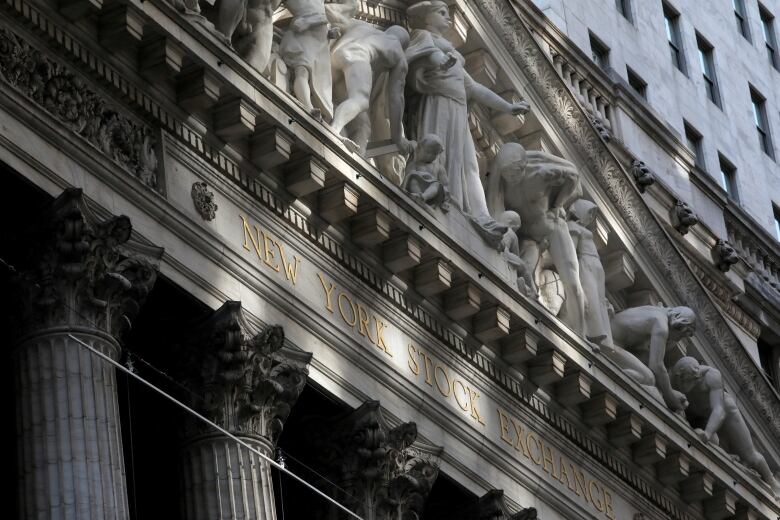 A building facade bears the words New York Stock Exchange in gold lettering.