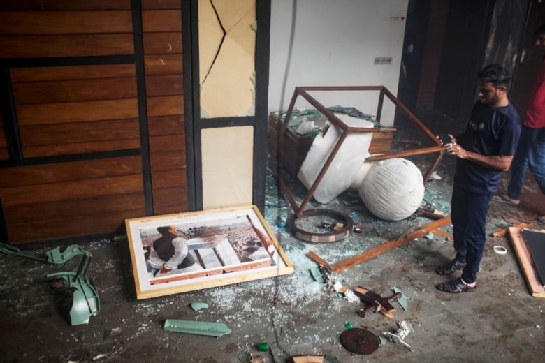 Broken objects lie the floor after protesters entered a memorial museum in Dhaka, Bangladesh.