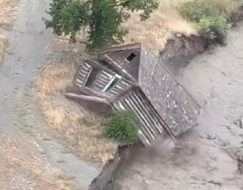 A cabin is collapsed in a river. 