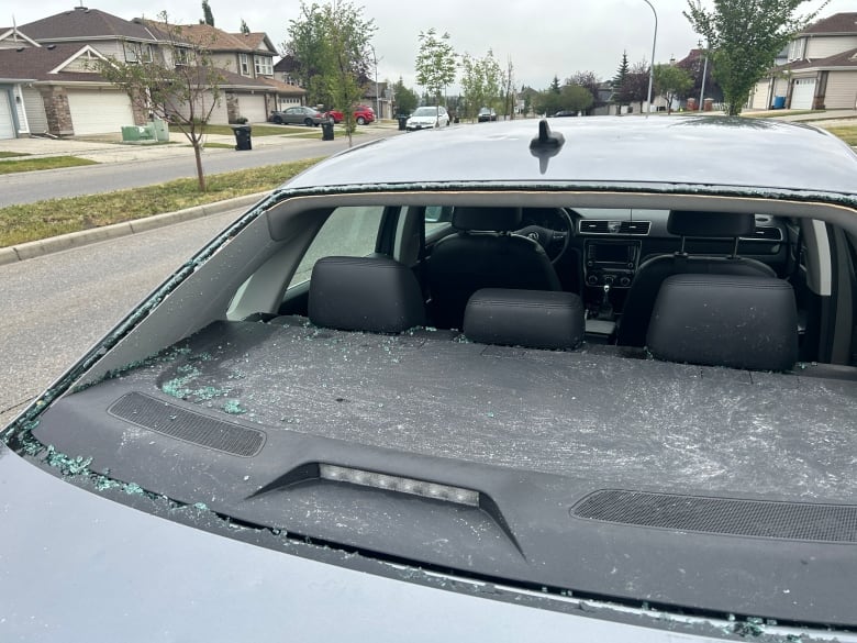 a rear car window is shattered.