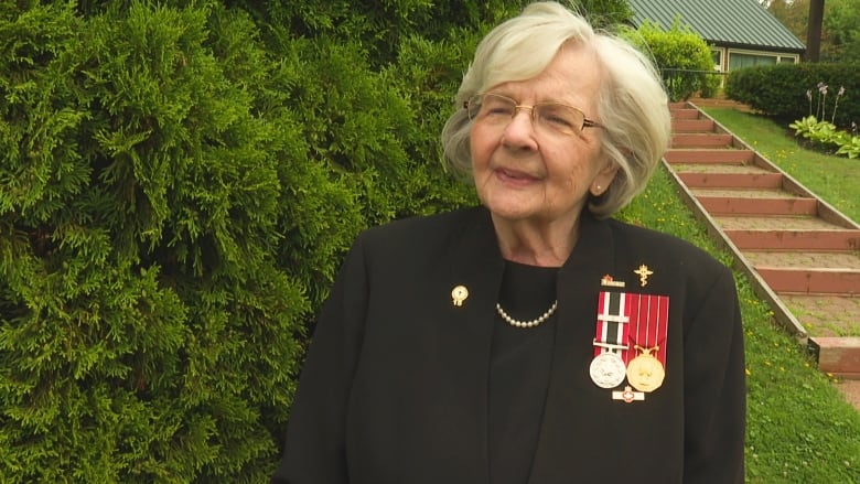 Woman with military medals on her chest.