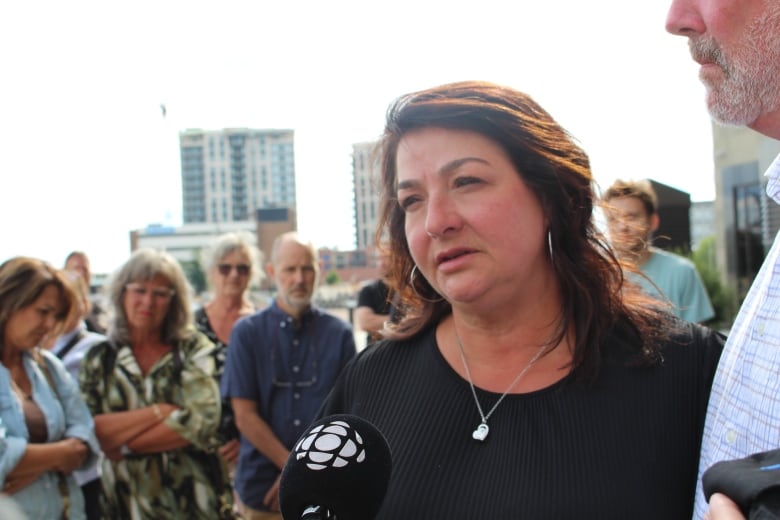 Lise Lamoureux speaks outside the Moncton courthouse.