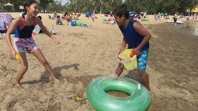 Two children on the beach at Sikome Lake.