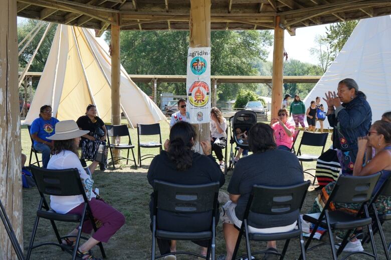 Attendees are pictured here singing and using their hands as part of the immersion experience.