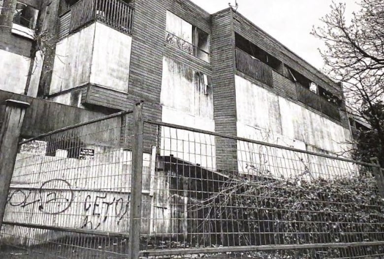 An abandoned building in black and white.